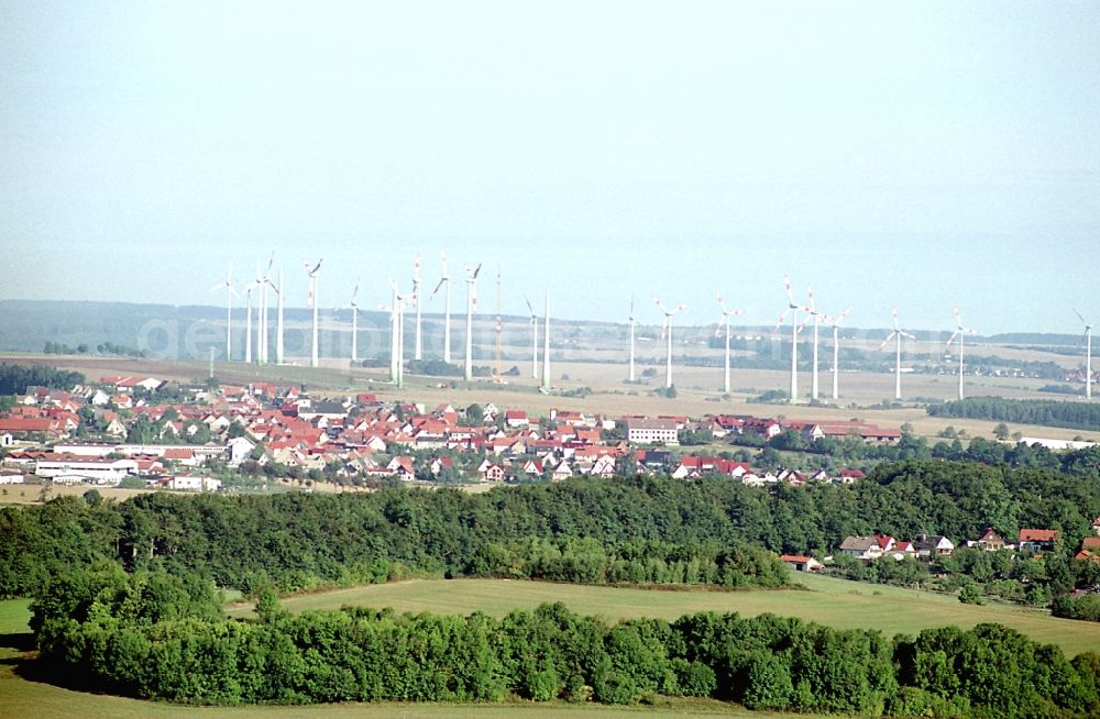 Dingelstädt from above - City view with silhouette of a group of wind power plants in Dingelstaedt in the state Thuringia, Germany