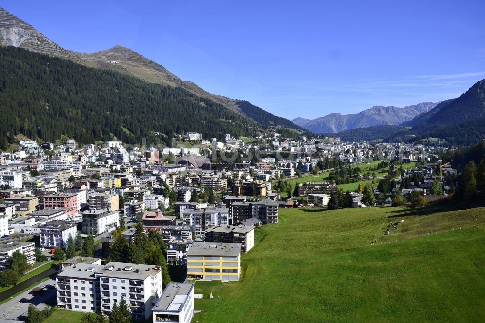 Aerial photograph Davos - Location view of the streets and houses of residential areas in the valley landscape surrounded by mountains in Davos in the canton Graubuenden, Switzerland