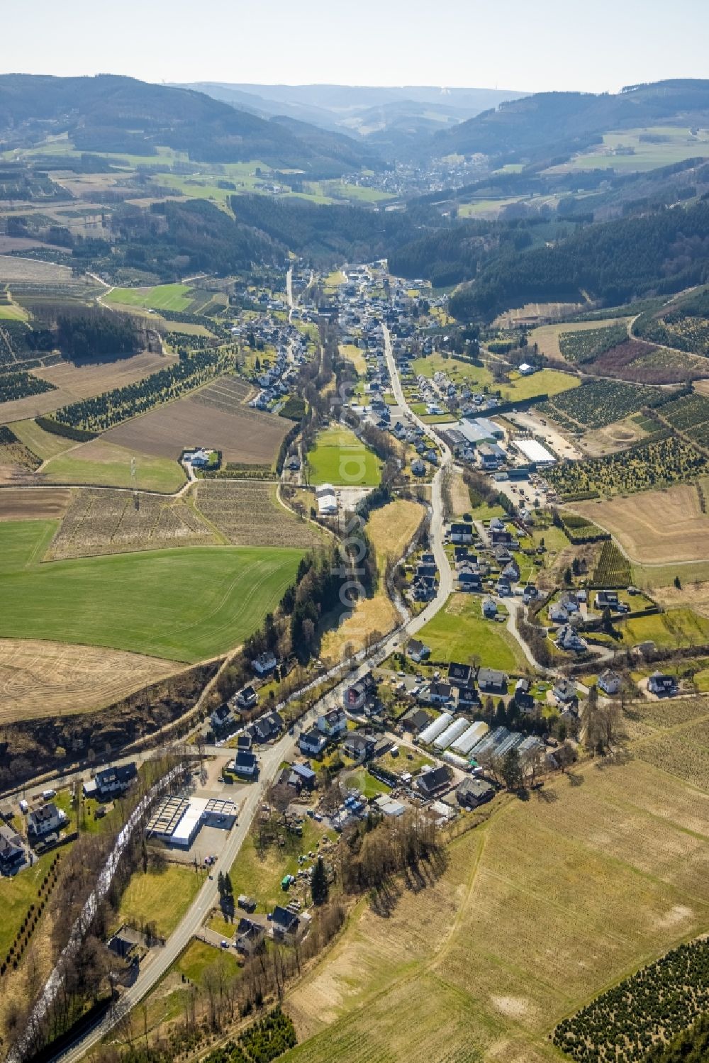 Heringhausen from above - Location view of the streets and houses of residential areas in the valley landscape surrounded by mountains in Heringhausen at Sauerland in the state North Rhine-Westphalia, Germany