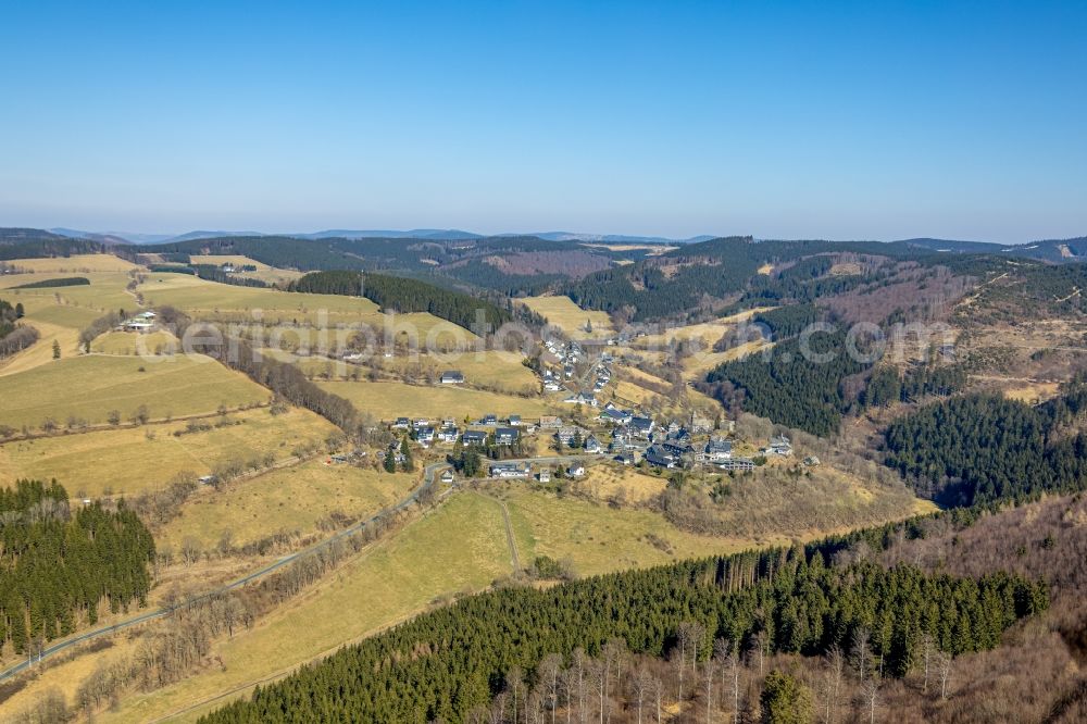 Nordenau from the bird's eye view: Location view of the streets and houses of residential areas in the valley landscape surrounded by mountains in Nordenau at Sauerland in the state North Rhine-Westphalia, Germany