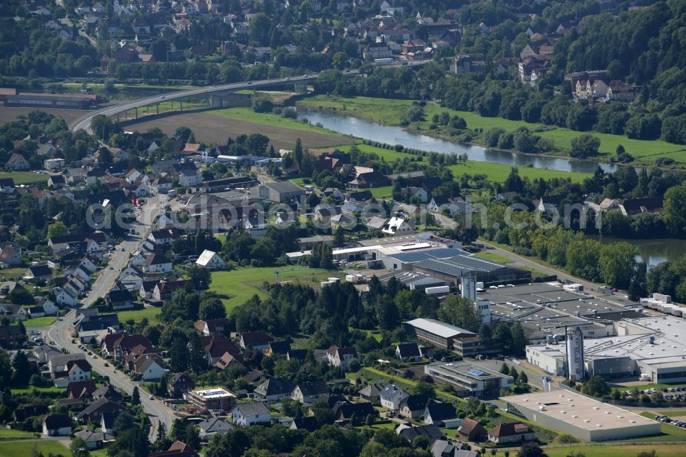 Uffeln from the bird's eye view: View of the village of Uffeln on the Eastern riverbank of the river Weser in the state of North Rhine-Westphalia. View from the North over the industrial and commercial area on pond Kiesteich. Mindener Strasse takes its course through the village