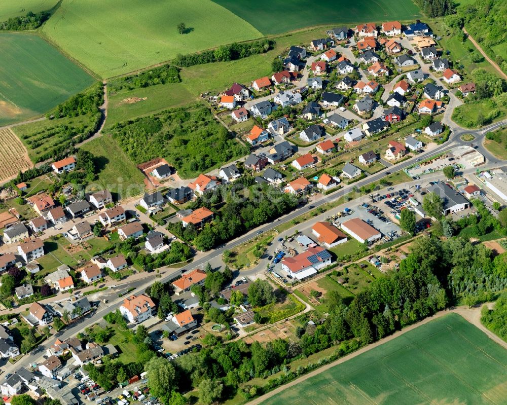 Weinsheim from the bird's eye view: View of Weinsheim in the state of Rhineland-Palatinate. Weinsheim is a borough and municipiality in the county district of Bad Kreuznach. It is located in the Nature Park Soonwald-Nahe. The Ellerbach creek takes its course through the village. Weinsheim includes three hamlets, two churches and the old town hall. The borough mainly consists of single family homes and residential areas