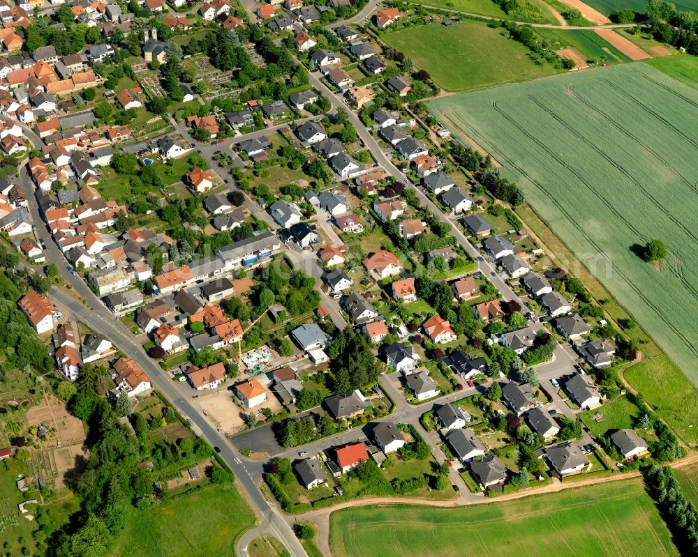 Weinsheim from the bird's eye view: View of Weinsheim in the state of Rhineland-Palatinate. Weinsheim is a borough and municipiality in the county district of Bad Kreuznach. It is located in the Nature Park Soonwald-Nahe. The Ellerbach creek takes its course through the village. Weinsheim includes three hamlets, two churches and the old town hall. The borough mainly consists of single family homes and residential areas