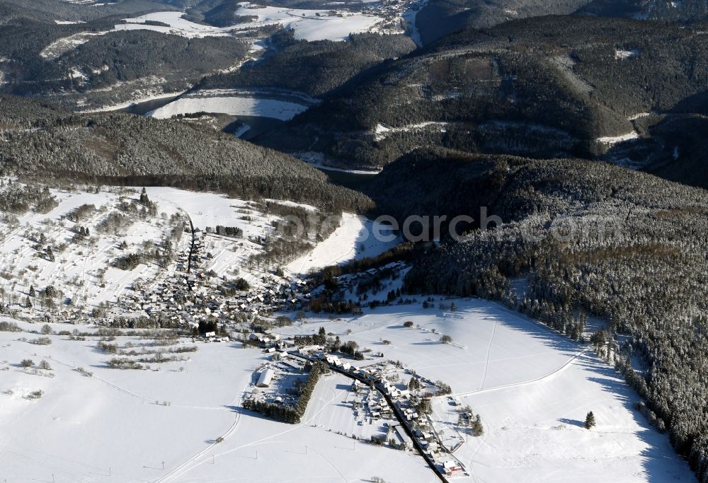 Deesbach from above - View of the wintry snow covered Deesbach with its hilly landscape in the state of Thuringia. The background shows the dam and barrier lake of Leibis-Lichte