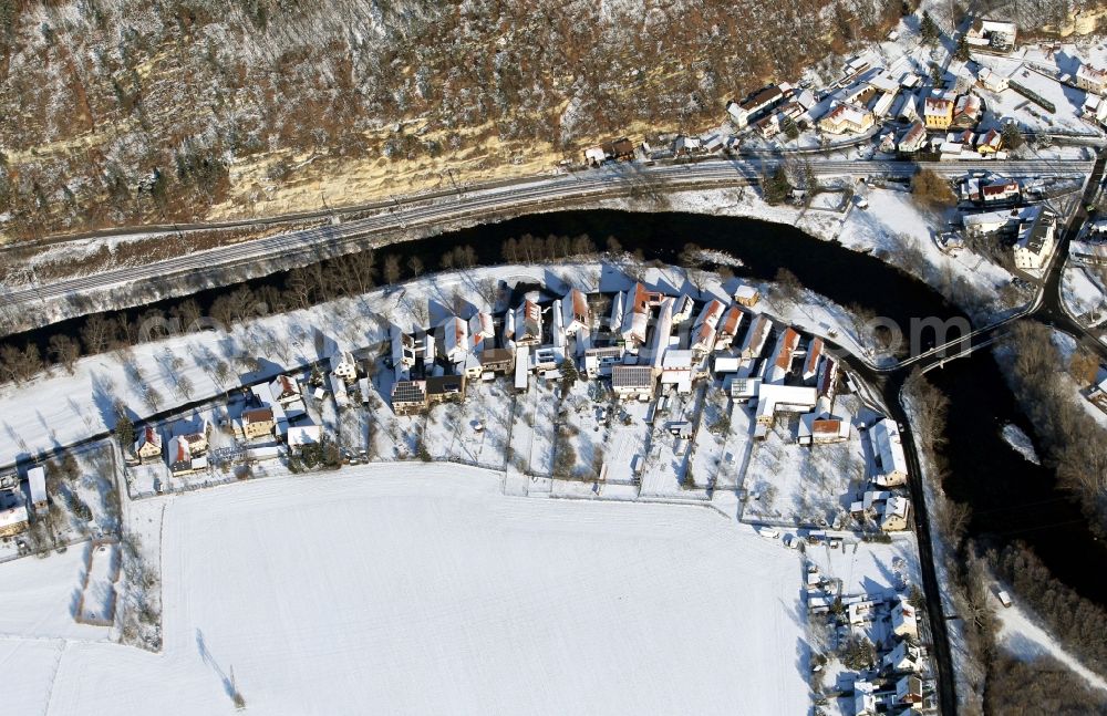 Aerial image Saalfeld/Saale - View of the snow-covered village of Remschuetz on the riverbank of the river Saale in the state of Thuringia