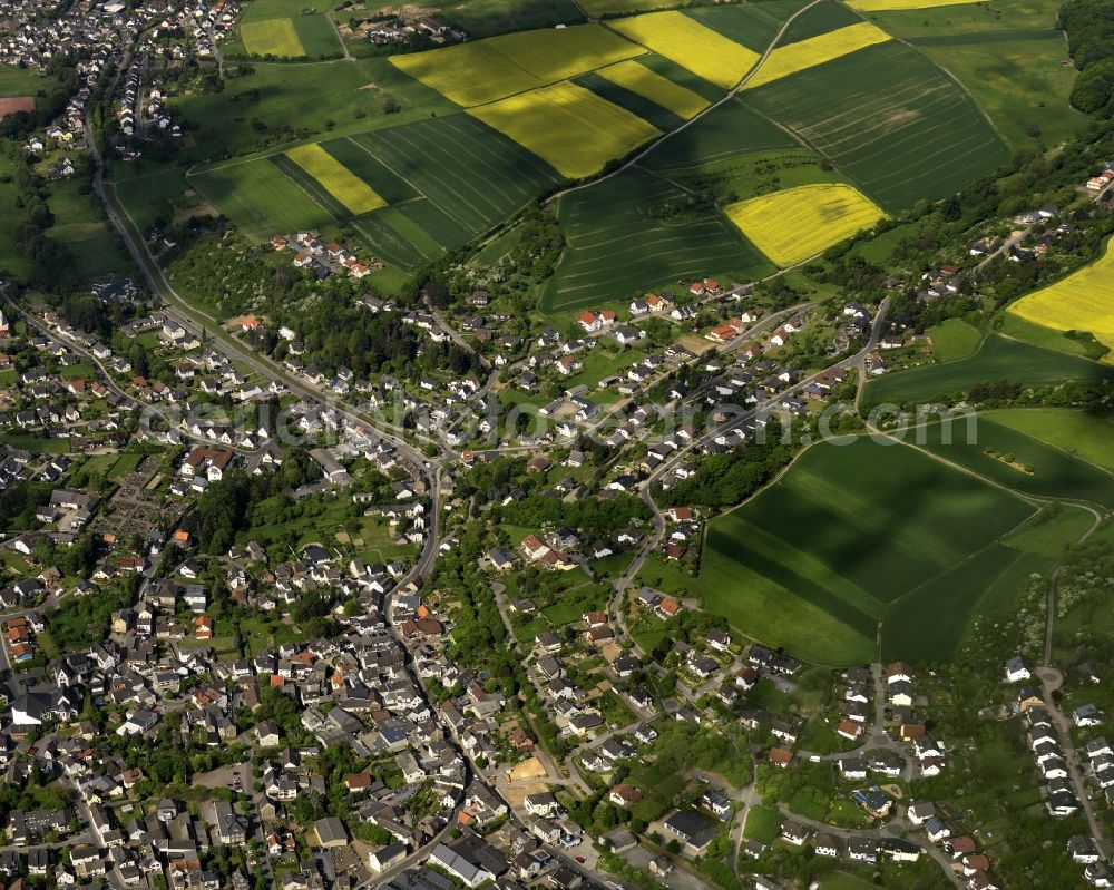 Niederzissen from above - View of the centre of the borough of Niederzissen in the state of Rhineland-Palatinate. The official tourist resort is located adjacent to the federal motorway A61. The centre is characterised by residential buildings, semi-detached and single family houses and agricultural businesses. The agricultural borough is surrounded by fields and meadows