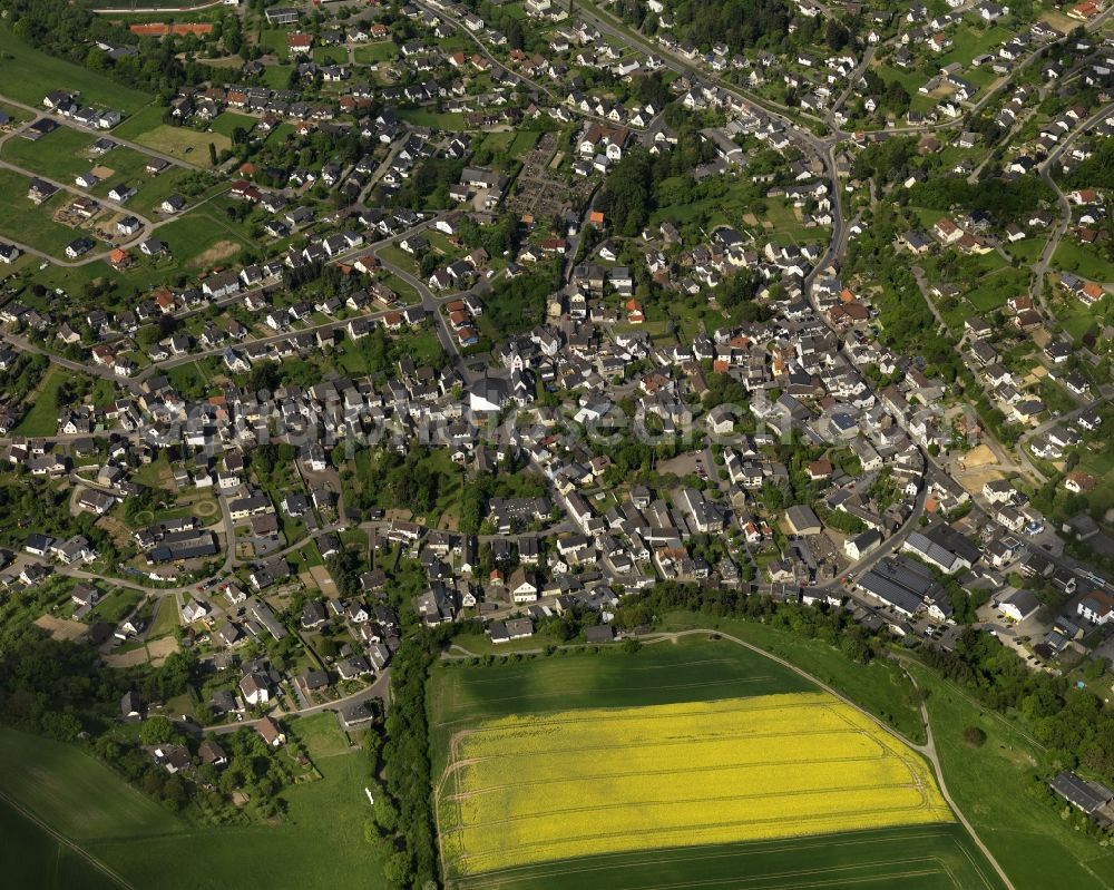 Niederzissen from the bird's eye view: View of the centre of the borough of Niederzissen in the state of Rhineland-Palatinate. The official tourist resort is located adjacent to the federal motorway A61. The centre is characterised by residential buildings, semi-detached and single family houses and agricultural businesses. The agricultural borough is surrounded by fields and meadows