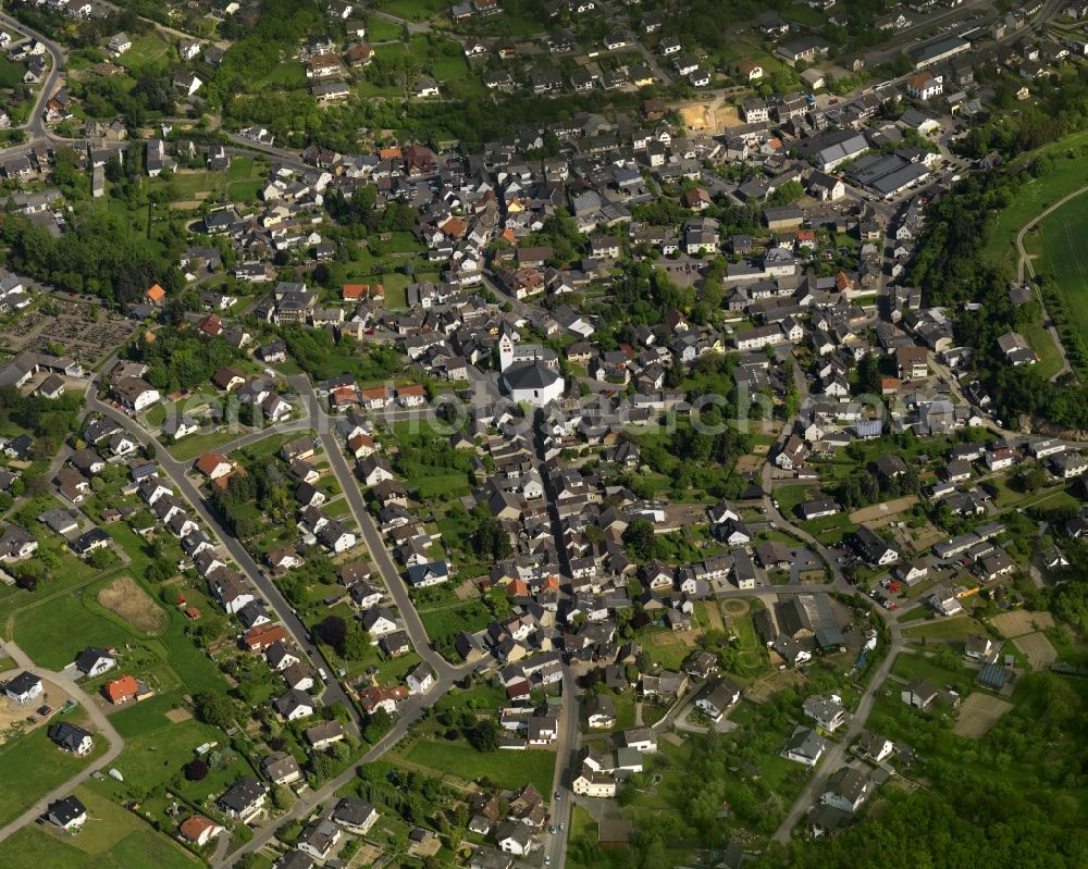 Aerial image Niederzissen - View of the centre of the borough of Niederzissen in the state of Rhineland-Palatinate. The official tourist resort is located adjacent to the federal motorway A61. The centre is characterised by residential buildings, semi-detached and single family houses and agricultural businesses. The agricultural borough is surrounded by fields and meadows