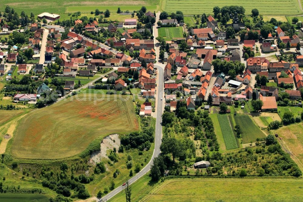 Etzleben from above - The commune Etzleben located on the northern edge of the Thuringian Basin in the state of Thuringia. The place is located on a railway line. The main occupation is agriculture Etzleben. Fertile fields surrounding the village. On a field is just farm implements on the go