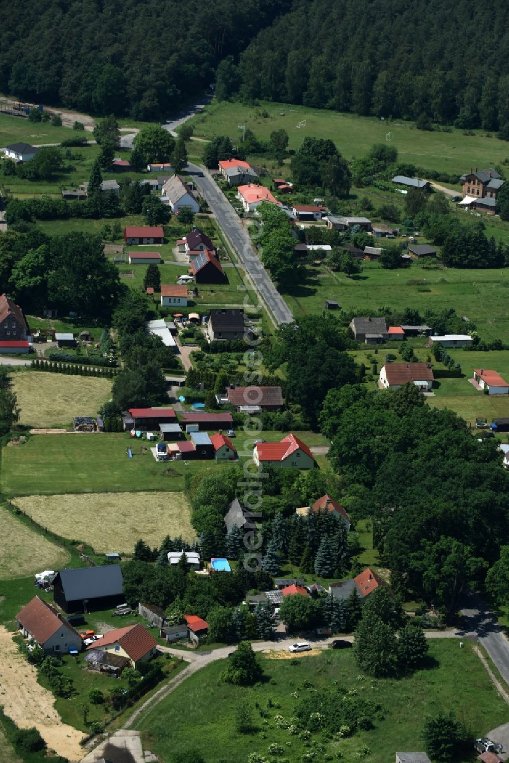 Schwarz from the bird's eye view: View of the village of Buschhof in the county of Schwarz in the state of Mecklenburg - Western Pomerania. The village is surrounded by fields and located on the edge of a forest and along Wittstocker Strasse, the L25