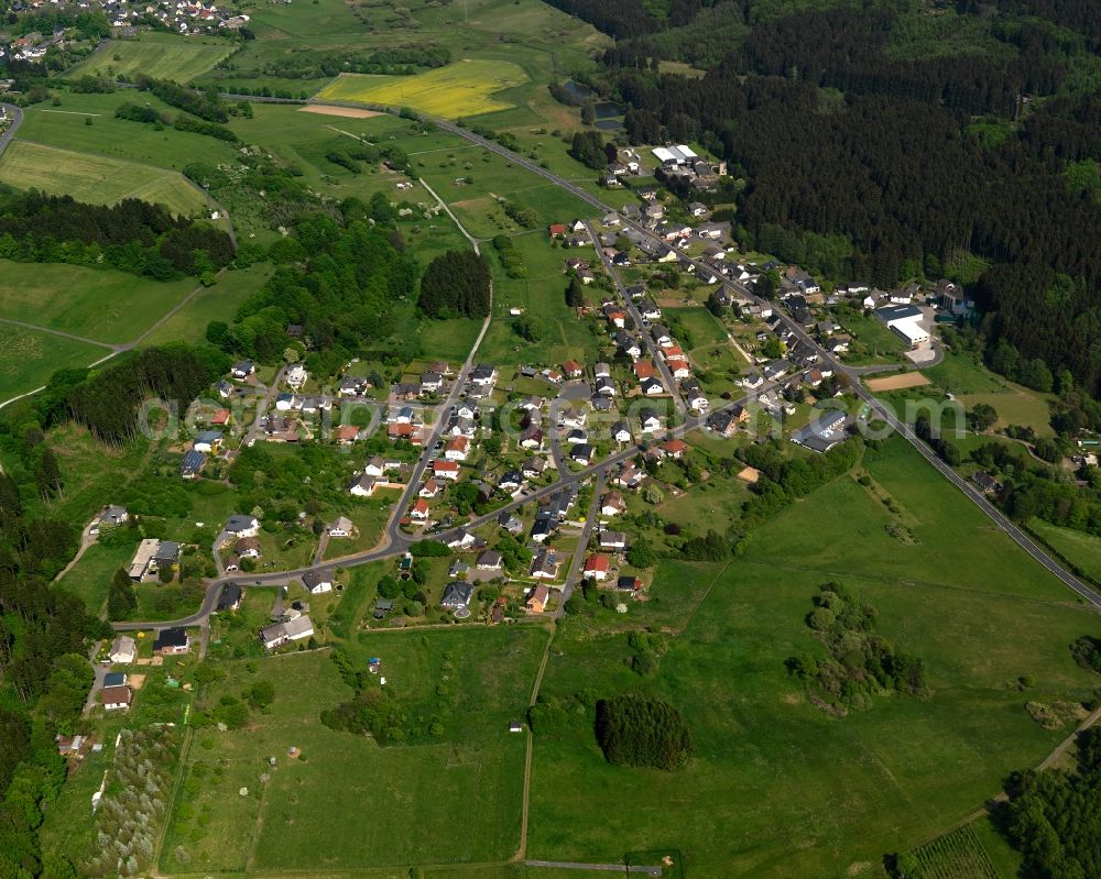 Aerial image Langenhahn - View of the Hintermuehlen part of the borough of Langenhahn in the state of Rhineland-Palatinate. The borough is located in the county district and region of Westerwald. The residential village is surrounded by fields and meadows. It is located at a forest in the South of the main village