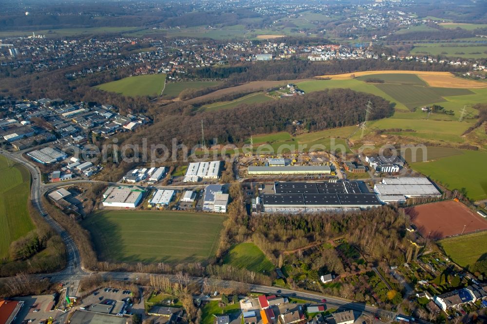 Hattingen from the bird's eye view: View of the Holthausen part of Hattingen in the state of North Rhine-Westphalia. View of the commercial area on Heiskampstrasse, the football pitch of SV Holthausen and a residential area