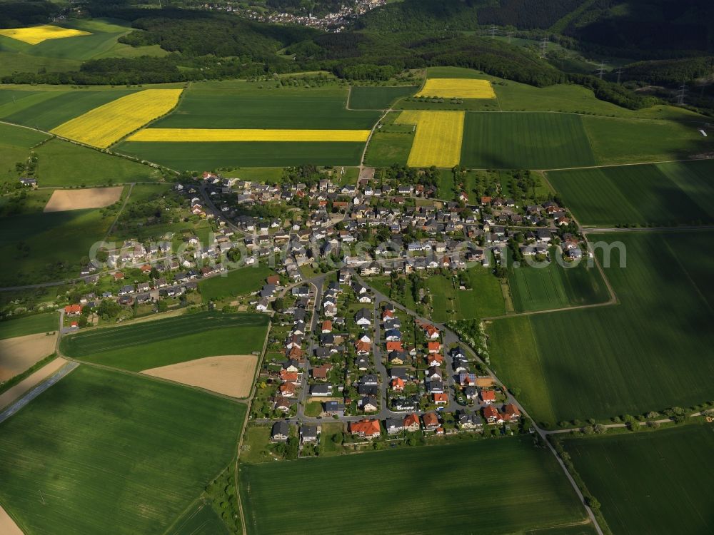 Burgbrohl from above - View of the Luetzingen part of the borough of Burgbrohl in the state of Rhineland-Palatinate. Luetzingen is located in the North of the borough. Its residential area is agriculturally informed and surrounded by fields - rapeseed fields - and agricultural land