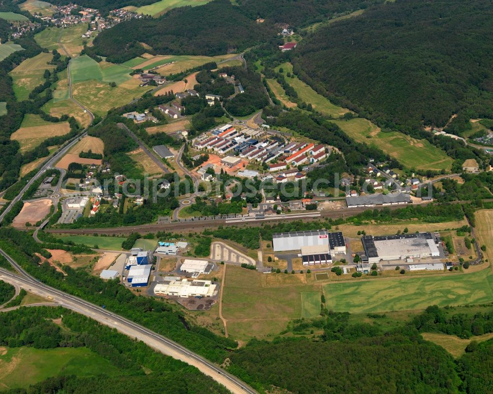 Hoppstädten-Weiersbach from above - View of the Neubruecke part of the borough and municipiality of Hoppstaedten-Weiersbach in the state of Rhineland-Palatinate. Hoppstaedten-Weiersbach is located in the county district of Birkenfeld and is surrounded by agricultural land, hills and forest. Neubruecke is located on the federal motorway A62 and is home to two industrial areas