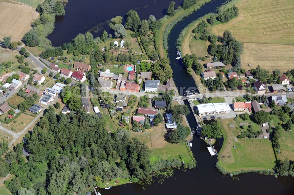 Aerial photograph Rietz-Neuendorf - View of the East of the village of Neubrueck on lake Wergensee in the borough of Rietz-Neuendorf in the state of Brandenburg. The residential village is surrounded by fields and forest along Spreestrasse. It is located on the Northern shore of the lake