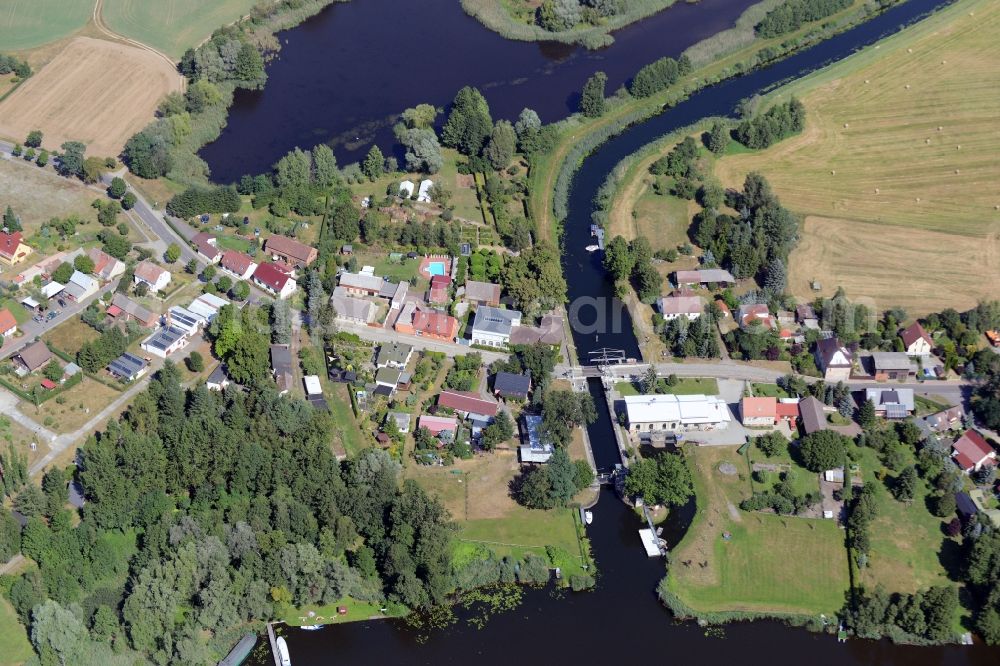 Rietz-Neuendorf from above - View of the East of the village of Neubrueck on lake Wergensee in the borough of Rietz-Neuendorf in the state of Brandenburg. The residential village is surrounded by fields and forest along Spreestrasse. It is located on the Northern shore of the lake