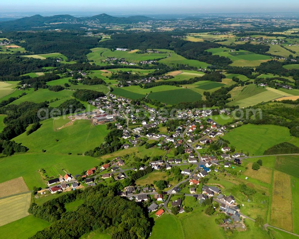 Buchholz from the bird's eye view: View of the Priestersberg part of Buchholz in the state of Rhineland-Palatinate. The borough and municipiality Buchholz is located in the county district of Neuwied on the edge of the Westerwald forest region and surrounded by fields, meadows and hills. Priestersberg is located in the Northwest of the core village and sits right on the state border to North Rhine-Westphalia