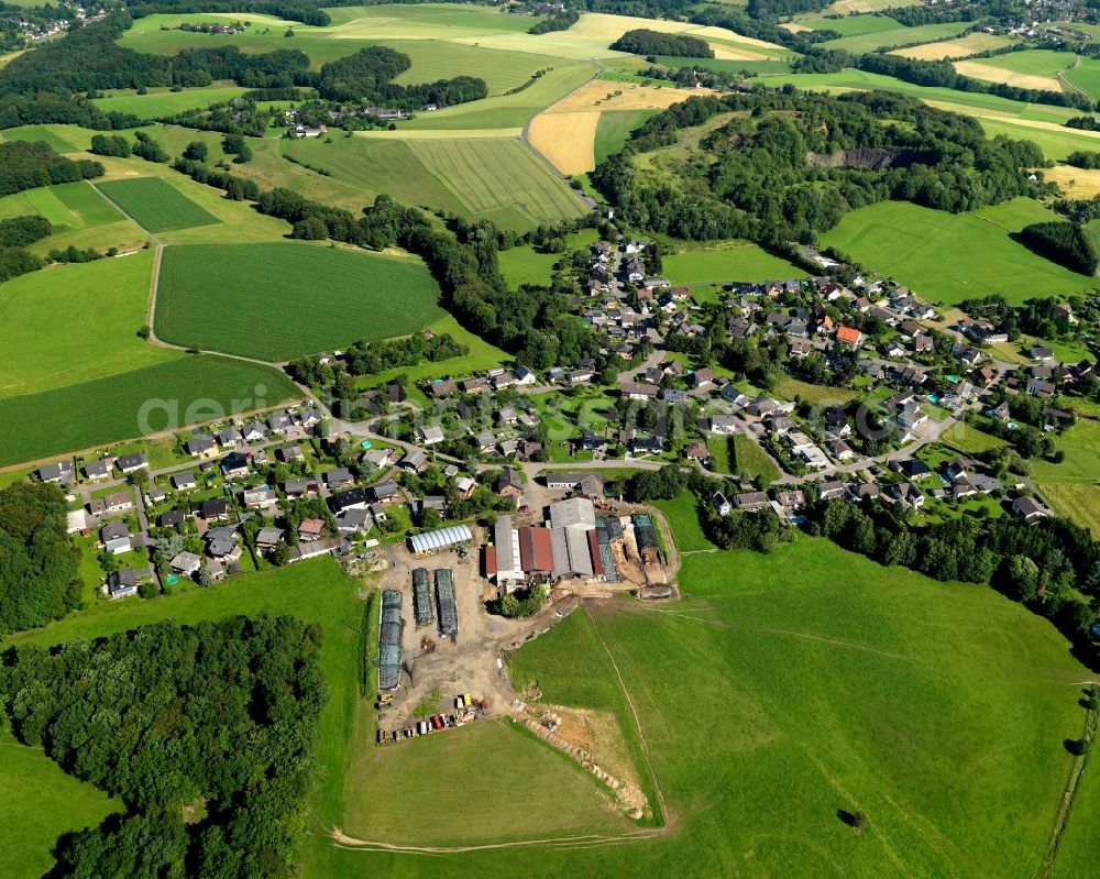 Aerial photograph Buchholz - View of the Priestersberg part of Buchholz in the state of Rhineland-Palatinate. The borough and municipiality Buchholz is located in the county district of Neuwied on the edge of the Westerwald forest region and surrounded by fields, meadows and hills. Priestersberg is located in the Northwest of the core village and sits right on the state border to North Rhine-Westphalia