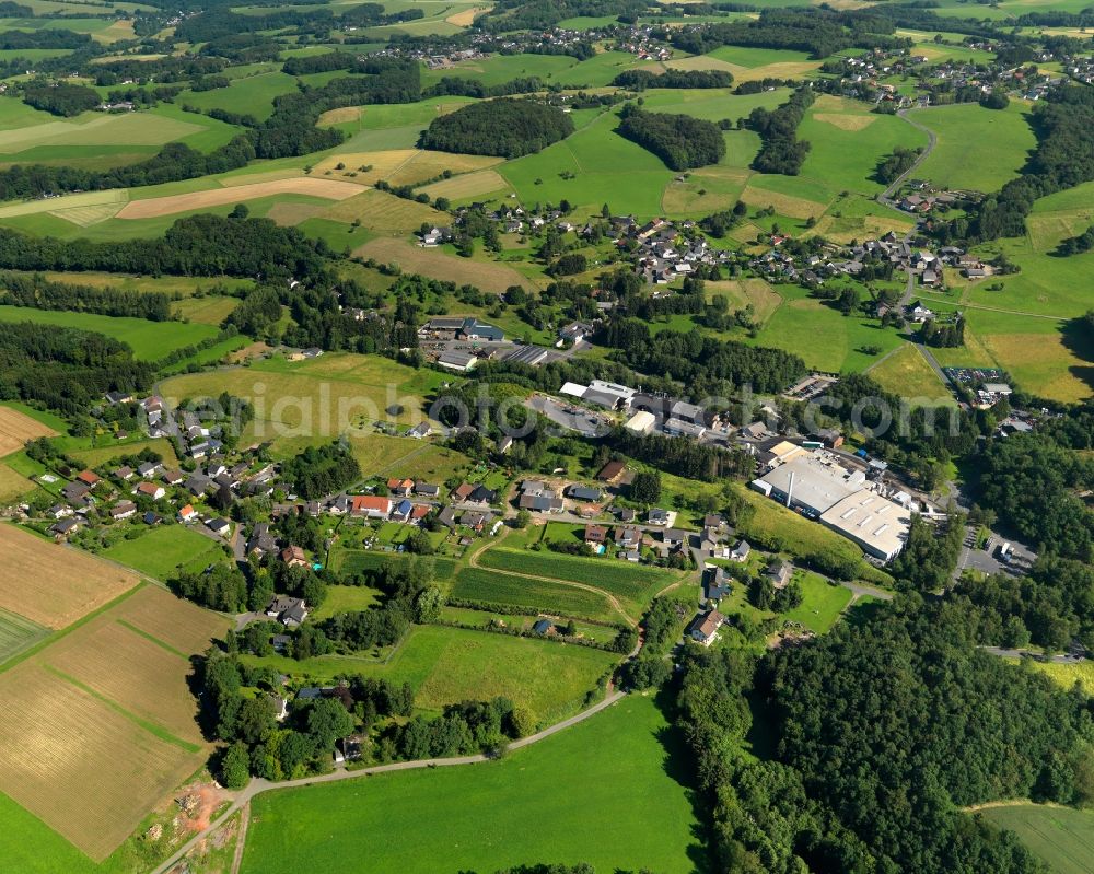 Buchholz from above - View of the Seifen part of Buchholz in the state of Rhineland-Palatinate. The borough and municipiality Buchholz is located in the county district of Neuwied on the edge of the Westerwald forest region and surrounded by fields, meadows and hills. Along Hanftalstrasse, there are several agricultural and forestry businesses and company buildings. Krautscheid is located in the North of Seifen