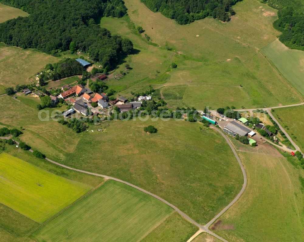 Baumholder from above - View of the Eschelbacherhof hamlet and part of Baumholder in the state of Rhineland-Palatinate. The small hamlet with a view houses and farms is surrounded by fields and meadows