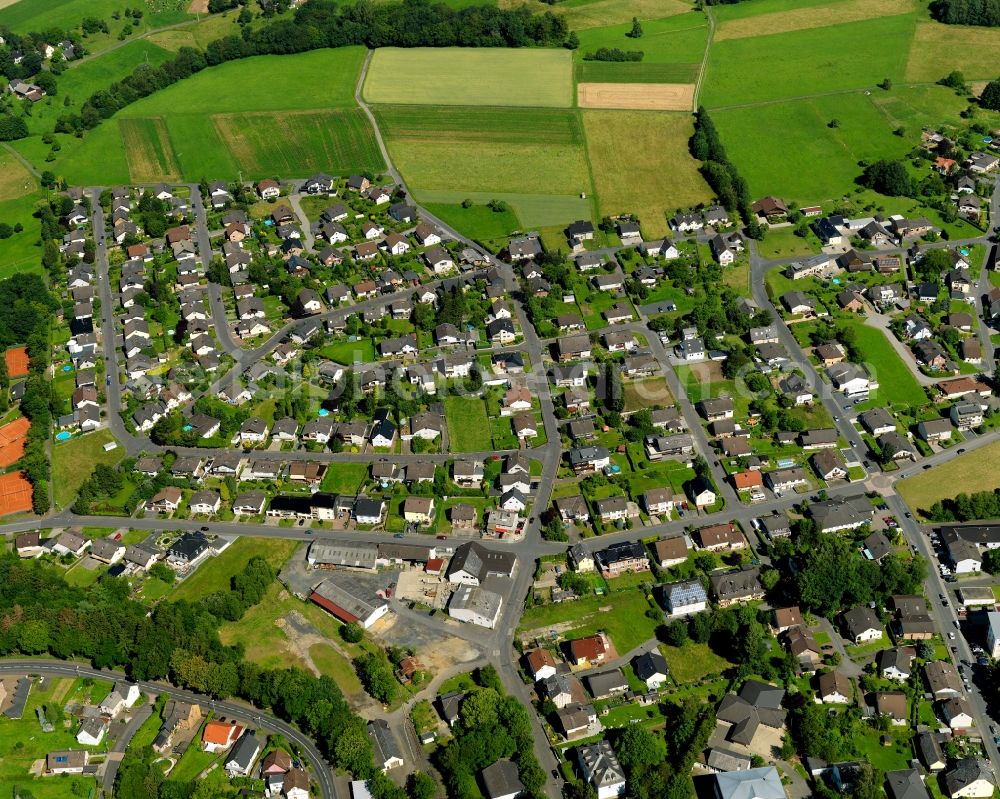 Asbach from the bird's eye view: View of a residential area in the Northwest of Asbach in the state of Rhineland-Palatinate. The borough and municipiality Asbach is located in the county district of Neuwied in the Niederwesterwald forest region between the Nature parks Rhine-Westerwald and Bergisches Land. Residential buildings and fields are located on Bahnhofstrasse in the Northwest of Asbach