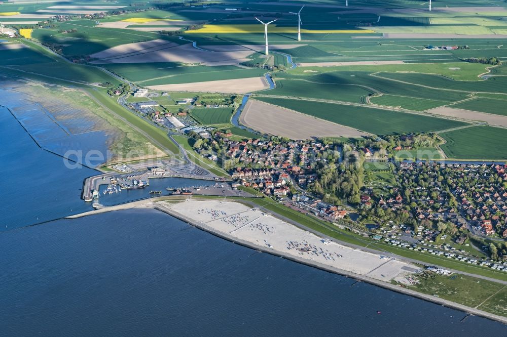 Neuharlingersiel from above - East Frisian Coast in Neuharlingersiel in the state of Lower Saxony. The borough of Neuharlingersiel is located in Harlinger Land in East Frisia on the North Sea shore. The coastal line consists of the Lower Saxony Wadden Sea which has been named a UNESCO world heritage site in 2009. The landscape is characterised by Wadden Sea, agriculture and fields