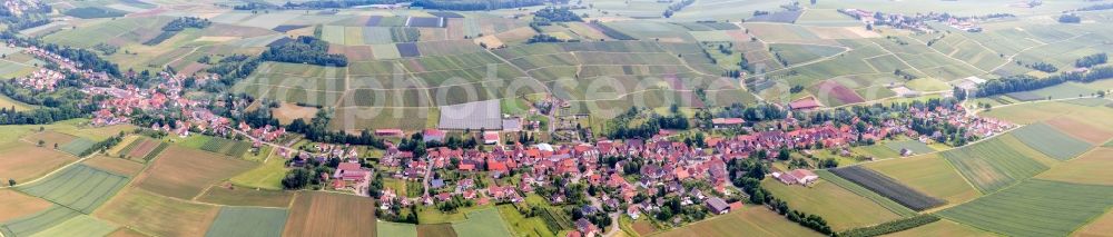 Steinseltz from the bird's eye view: Panoramic perspective Village - view on the edge of agricultural fields and farmland in Steinseltz in Grand Est, France