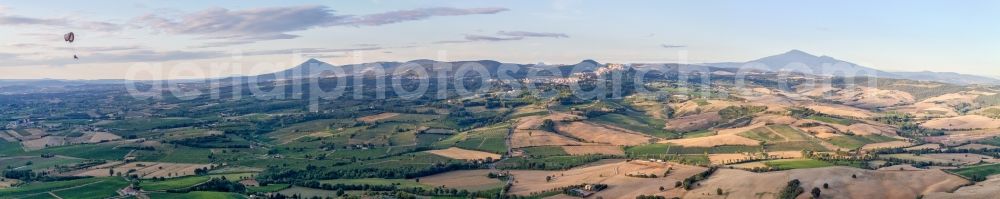 Montepulciano from the bird's eye view: Panoramic perspective of Rocky and mountainous landscape with Paraglider in Montepulciano in Toskana, Italy