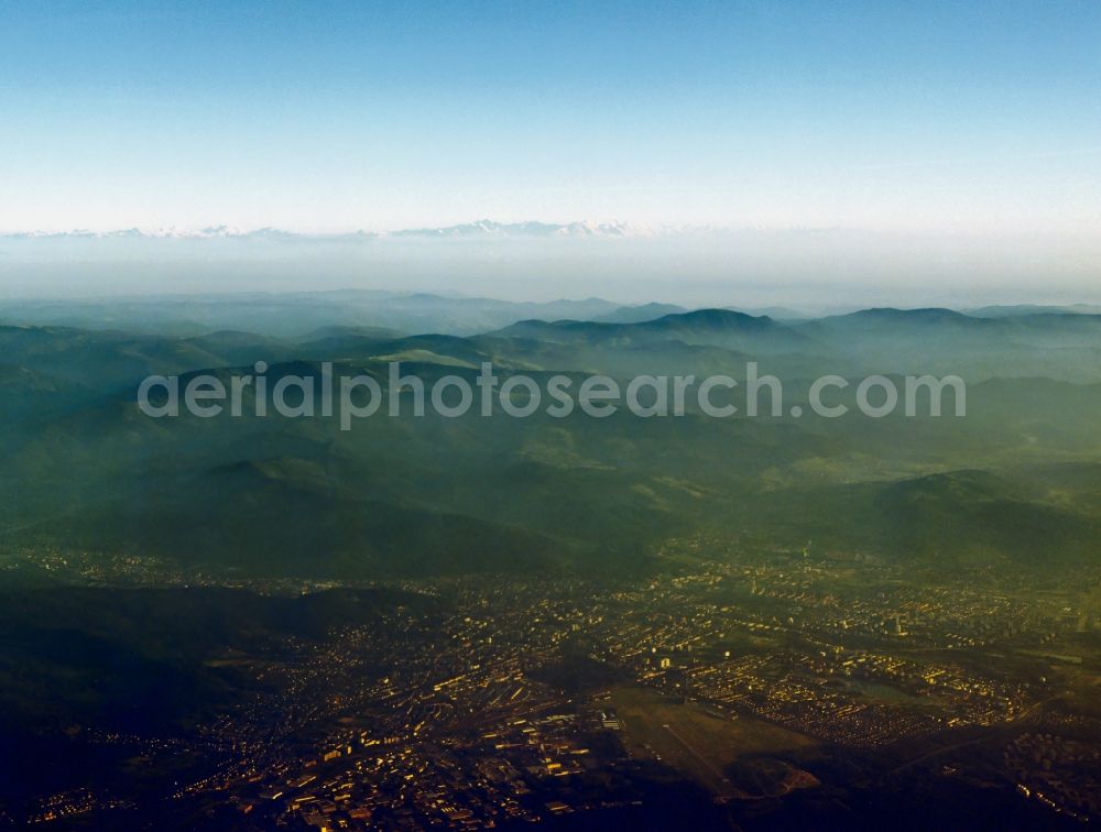 Freiburg im Breisgau from the bird's eye view: Panoramic view and landscape of the Black Forest around Freiburg in the state of Baden-Wuerttemberg. Behind Germany's southern most metropolitan area, the landscapes of the Breisgau region and the Black Forest are visible. Hills and mountains are standing in fog and mist