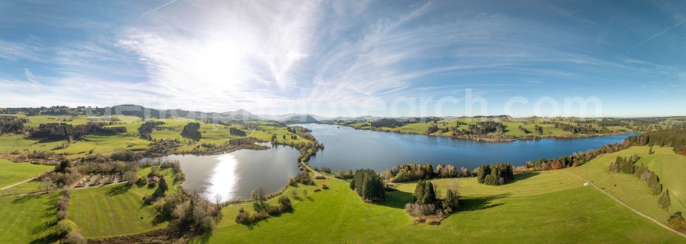 Sulzberg from above - Panoramic perspective impoundment and shore areas at the lake Rottachsee - Rottachspeicher on street Am Petersbach in Sulzberg in the state Bavaria, Germany