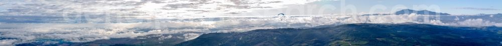 Aerial photograph Montepulciano - Panoramic perspective of Rocky and mountainous landscape with clouds and paraglider in Montepulciano in Toskana, Italy