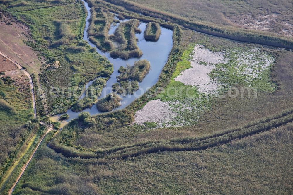 Aerial image Muro - Parc natural de sa Albufera de Mallorca or Parque natural de la Albufera de Mallorca with Ponds and Morast- water surface in a pond landscape in Muro in Balearic Islands, Spain