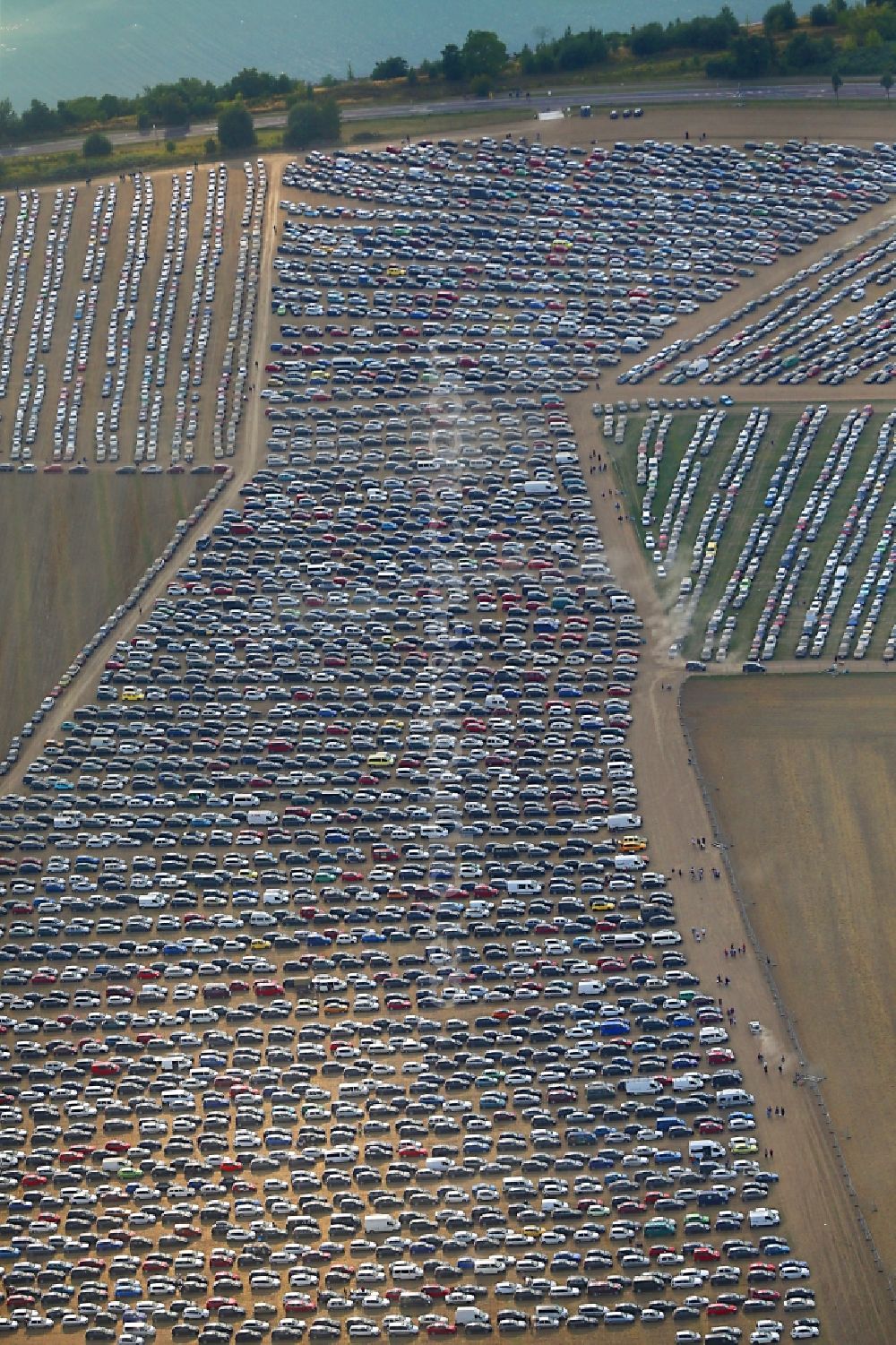 Großpösna from above - View of the parking places at the Area of the Higfield Festival, the most important Independent Rock estival in east germany riparian Lake stoermthal near Grosspoesna, saxony