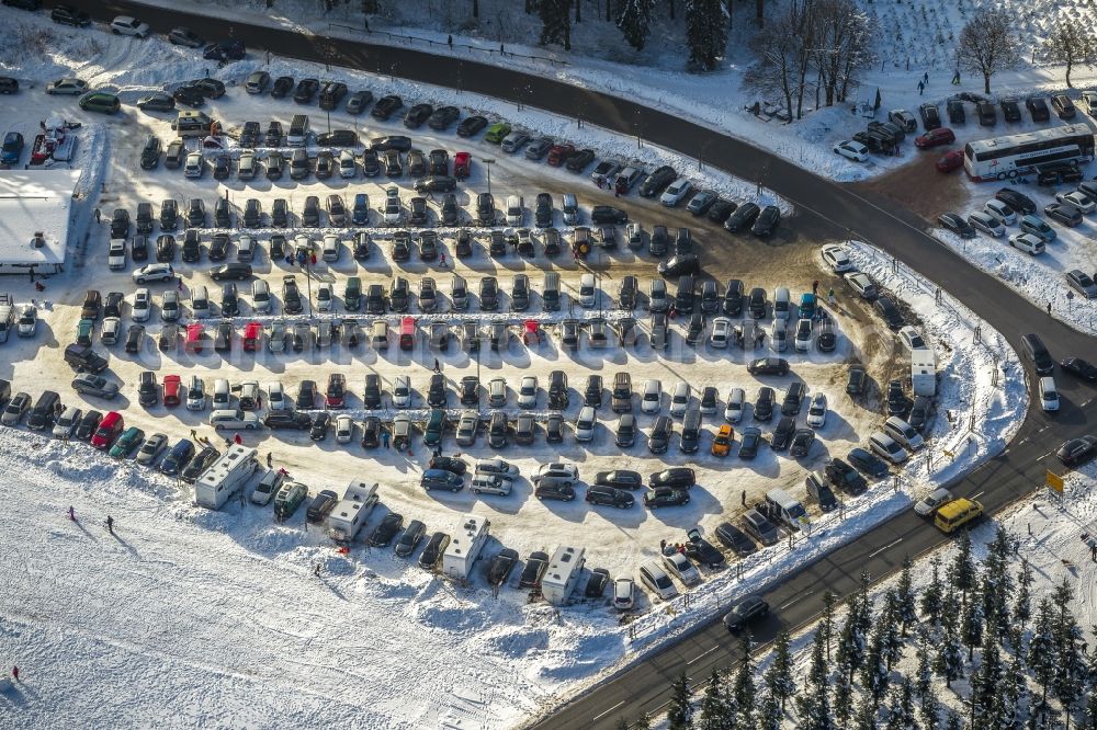 Winterberg from the bird's eye view: View of a snow covered car park at the winter sports area Skiliftkarussell in Winterberg in the district Hochsauerlandkreis HSK in the state North Rhine-Westphalia. The parking lot is one of six parking areas of the winter sports area which can be used free of charge