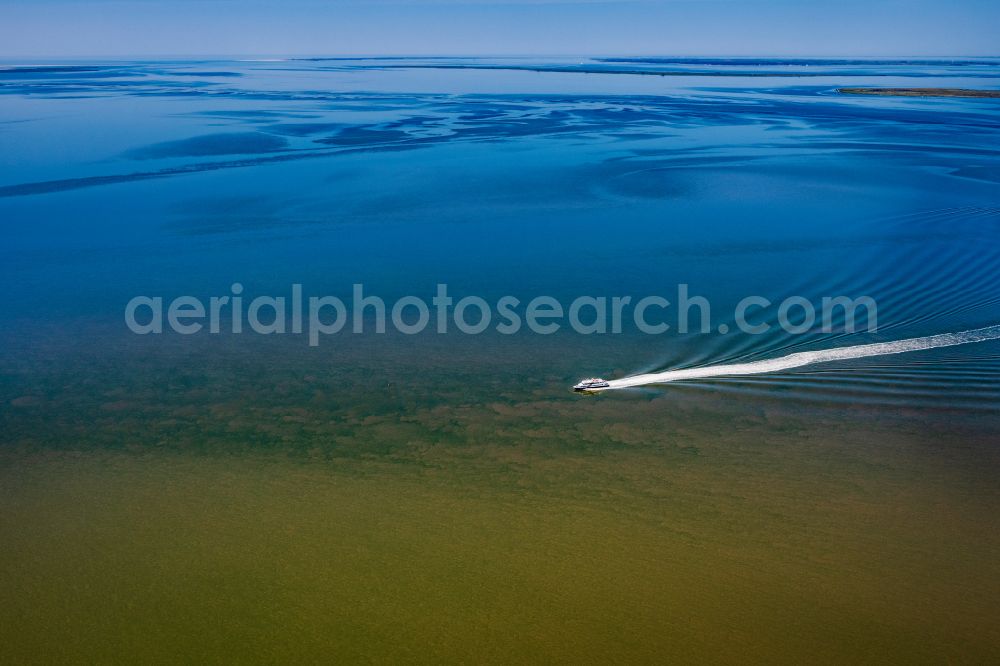 Nordstrand from above - Passenger ship Adler Express at full speed near the peninsula Nordstrand in the Wadden Sea in the state Schleswig-Holstein, Germany