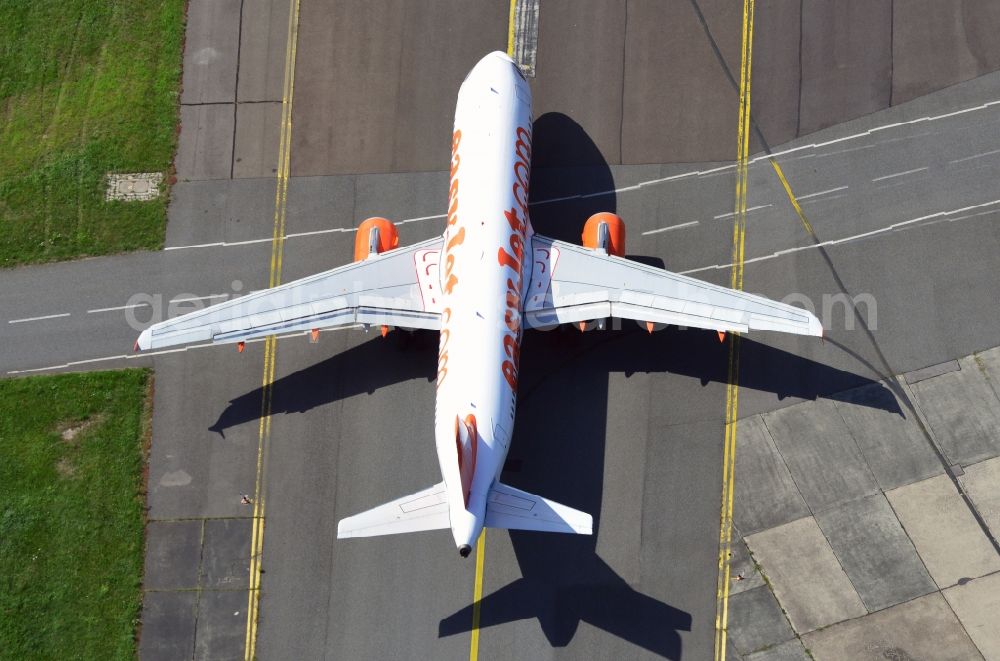 Schönefeld from the bird's eye view: Passenger - aircraft type Airbus A318-111 of airline Easy Jet on the runway to the starting point in Schönefeld in Brandenburg