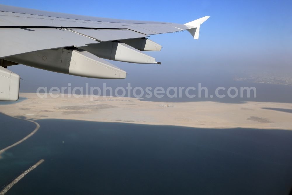 Aerial image Dubai - Airliner - Passenger aircraft Airbus A380 climbing out to the west over the Deira Islands in the Persian Gulf in Dubai in United Arab Emirates. The artificial landfill islands give space for 30 000 people and expands the coastline with 21 kilometres of beaches