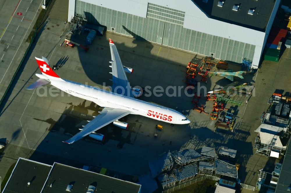 Aerial image Dresden - Passenger airplane Airbus A340-313 of Swiss with the callsign HB-JMH in parking position - parking area at the airport in the district Klotzsche in Dresden in the state Saxony, Germany