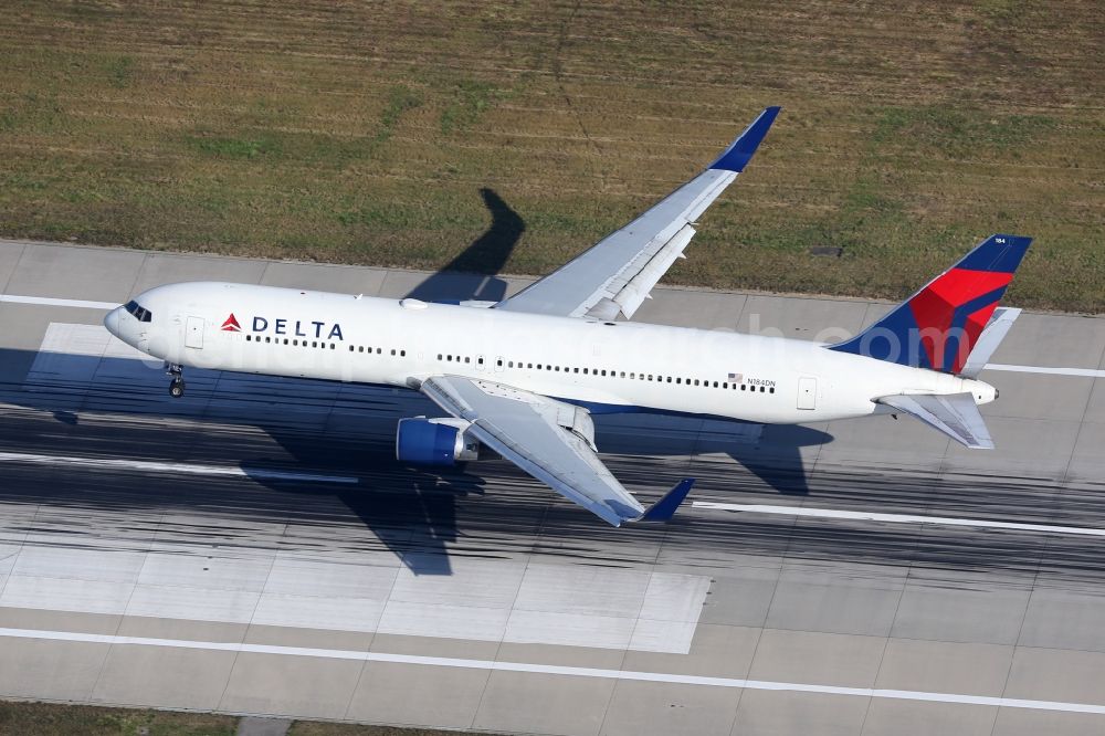 Aerial photograph Stuttgart - Passenger aircraft Boeing 767-332 (ER) of the airline Delta Air Lines with the identification N184DN at the start and climb over the airport in Stuttgart in the state of Baden-Wuerttemberg