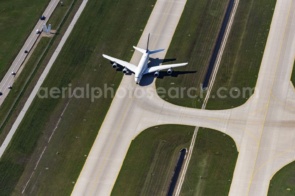 München from above - Airliner- Passenger aircraft A 380 of Lufthansa rolling on the apron of the airport in Munich in the state Bavaria, Germany