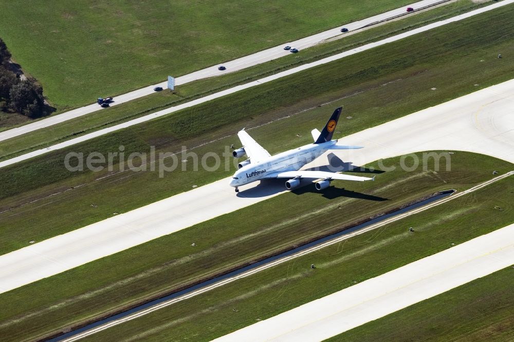 Aerial image München - Airliner- Passenger aircraft A 380 of Lufthansa rolling on the apron of the airport in Munich in the state Bavaria, Germany