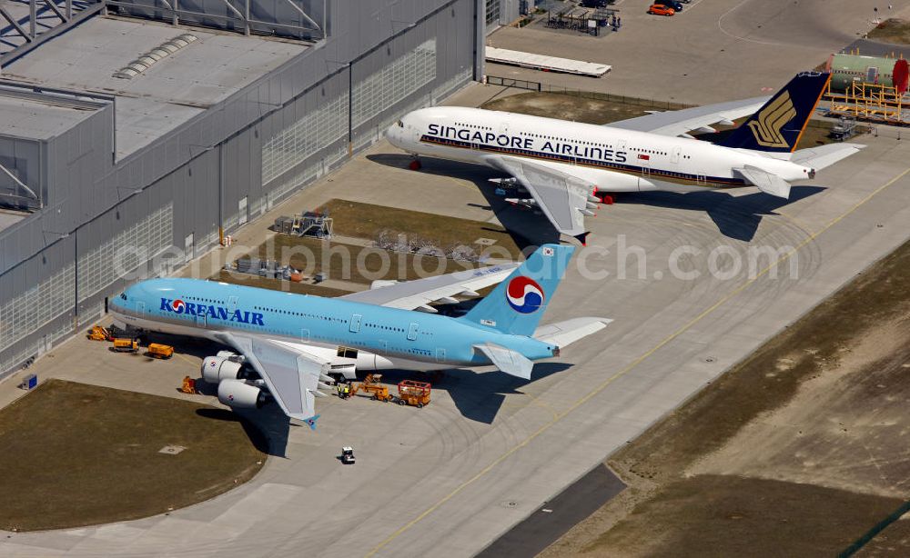 Hamburg Finkenwerder from the bird's eye view: Blick auf fertige, zur Auslieferung an die bestellenden Airlines bereitstehende Passagierflugzeuge A380 auf dem Flugplatz Hamburg-Finkenwerder. Weltweit wird das Luftfahrzeug von renommierten Fluggesellschaften wie LUFTHANSA , AIR FRANCE und Singapore Airlines geflogen.