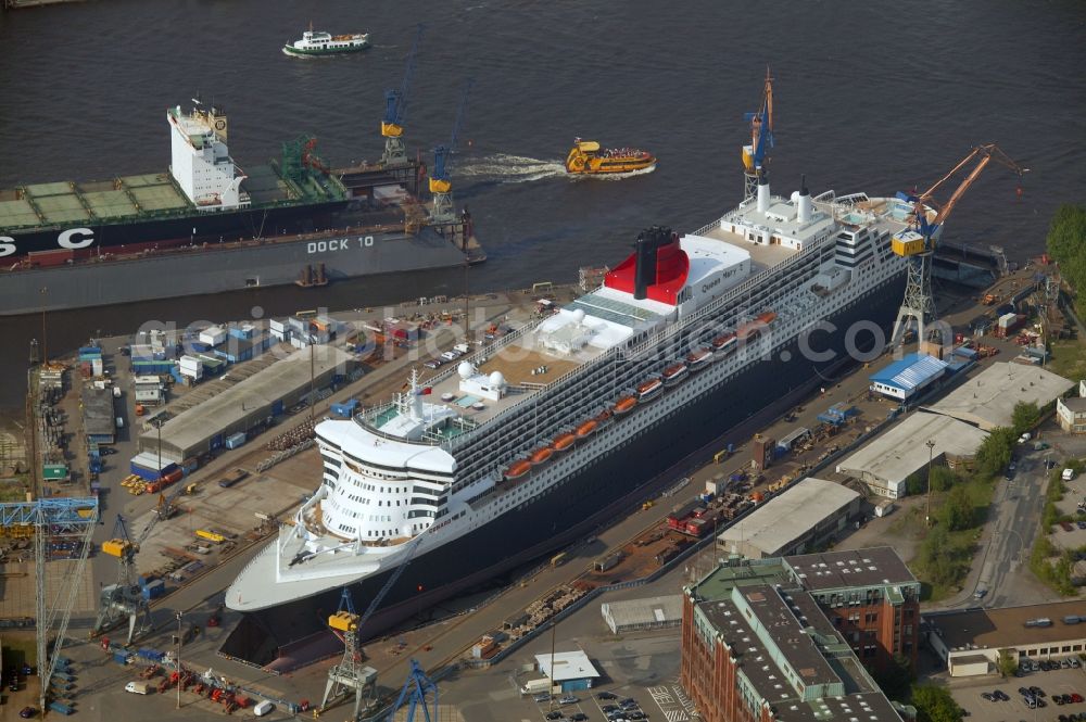 Aerial photograph Hamburg - Passenger ship and luxury liner Queen Mary 2 on the Elbe 17 dry dock of Blohm and Voss in Hamburg company for maintenance and repairs. It is at 345 meters, the largest passenger ship in the world. The German shipyard Blohm and Voss is a subsidiary of ThyssenKrupp AG