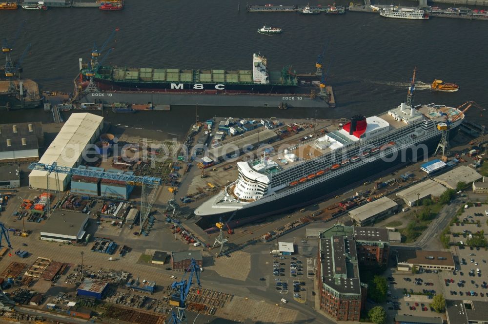 Hamburg from the bird's eye view: Passenger ship and luxury liner Queen Mary 2 on the Elbe 17 dry dock of Blohm and Voss in Hamburg company for maintenance and repairs. It is at 345 meters, the largest passenger ship in the world. The German shipyard Blohm and Voss is a subsidiary of ThyssenKrupp AG