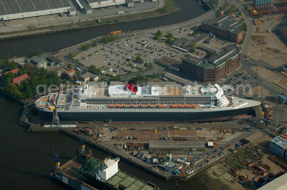 Aerial image Hamburg - Passenger ship and luxury liner Queen Mary 2 on the Elbe 17 dry dock of Blohm and Voss in Hamburg company for maintenance and repairs. It is at 345 meters, the largest passenger ship in the world. The German shipyard Blohm and Voss is a subsidiary of ThyssenKrupp AG