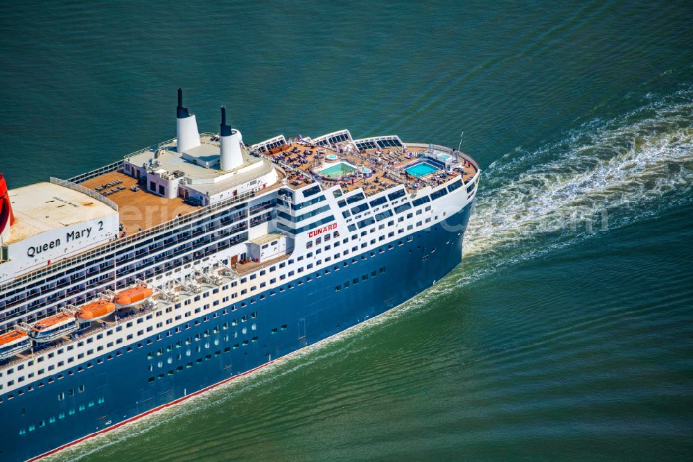 Aerial image Balje - Passenger ship and luxury liner ship Queen Mary 2 at full speed on the Elbe near Balje in the district of Stade