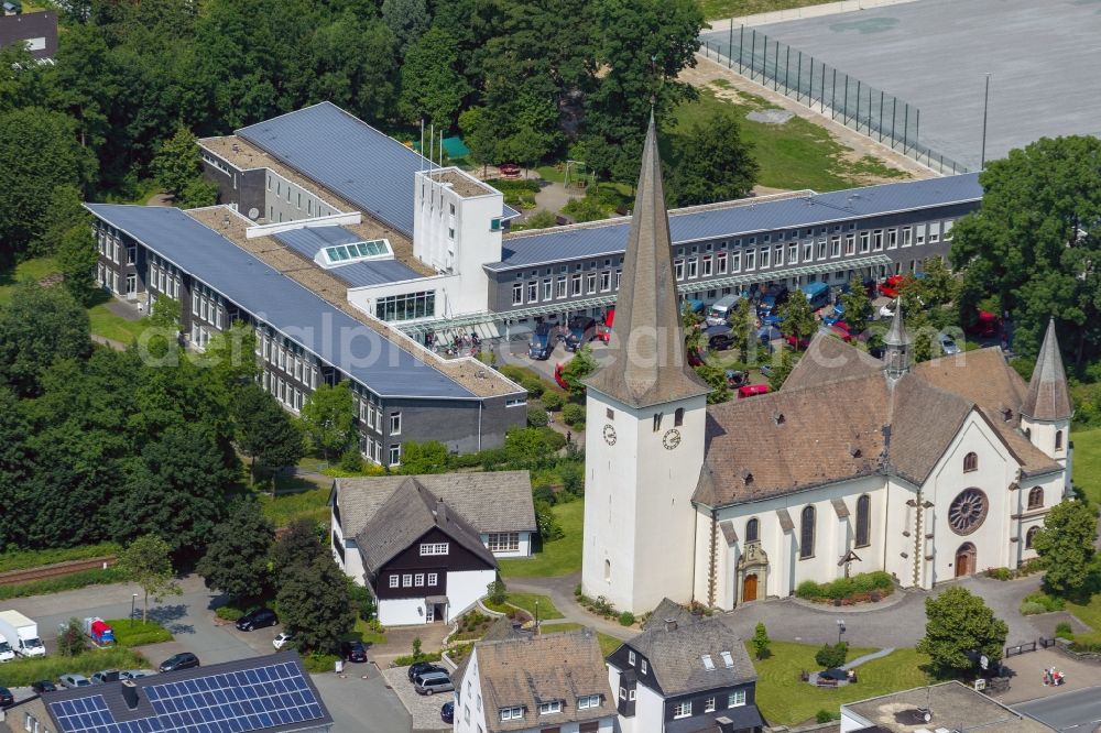 Aerial image Olsberg Bigge - Parish church St. Martin overlooking the special school for physical development in the district Bigge in Olsberg in North Rhine-Westphalia