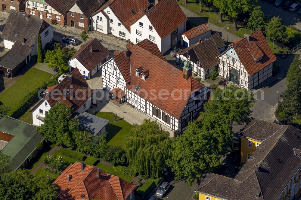 Aerial image Rietberg - Parish church in opposite of Haus Muente in the Muentestrasse in Rietberg in the state North Rhine-Westphalia. The building of this church is a half-timbered building