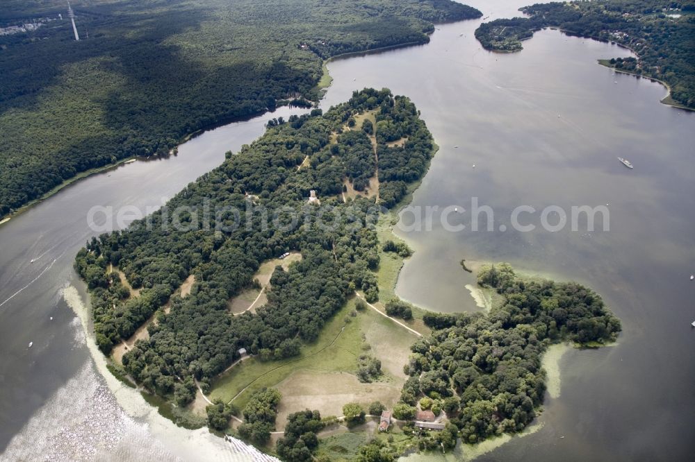 Aerial image Berlin - The Pfaueninsel Palace (peacock island) in the Wannsee part of the district of Steglitz - Zehlendorf in Berlin. The palace is located on the shore of the river Havel. It was built in the 18th century as a pleasure palace. It was designed in a romantic ruin architecture style and is surrounded by park like landscape on the river. Today it is part of the Potsdam palace and park compound and part of UNESCO world heritage