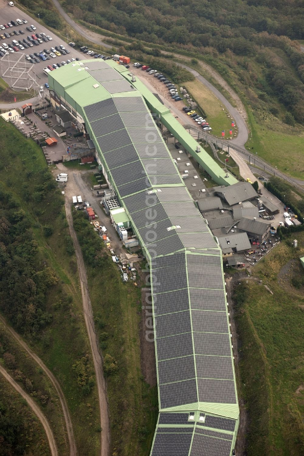 Aerial image Bottrop - Photovoltaic system - solar power plant on the roof of the summer toboggan run on the heap in Bottrop in North Rhine-Westphalia